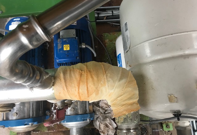 A leaking pipe in a CHP Plant undergoes repair with a SylWrap HD Pipe Repair Bandage