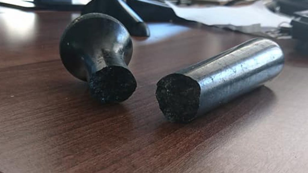 A cracked granite pestle part of a pestle and mortar set before undergoing repair with an epoxy adhesive