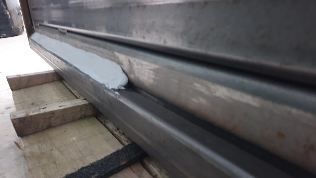 Sylmasta AB Original Epoxy Putty formed into a bevelled edge to help with protection of a wood gate from rot