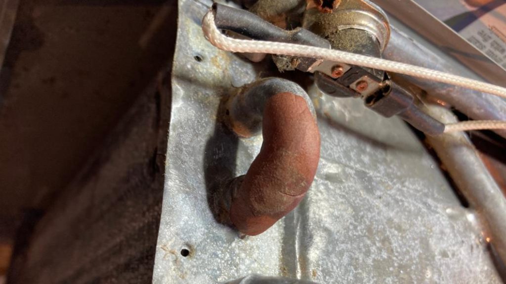 Superfast Copper Epoxy Putty applied to a burst pipe as part of the repair of a portable hot shower unit