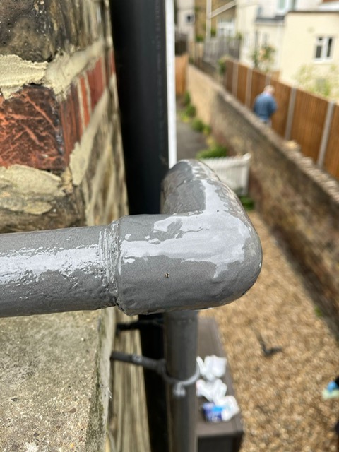 Repair of a 90 degree elbow on a shared water supply pipe made using Liquid Metal Epoxy Coating