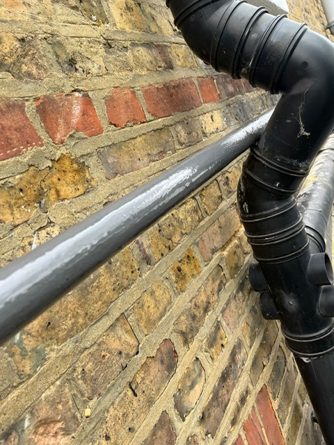 Liquid Metal Epoxy Coating reinforces a shared water supply pipe during repair