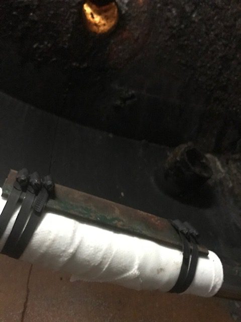 SylWrap HD and a steel deflector plate used to repair and protect a pipe in a farm biomass power plant heating tank