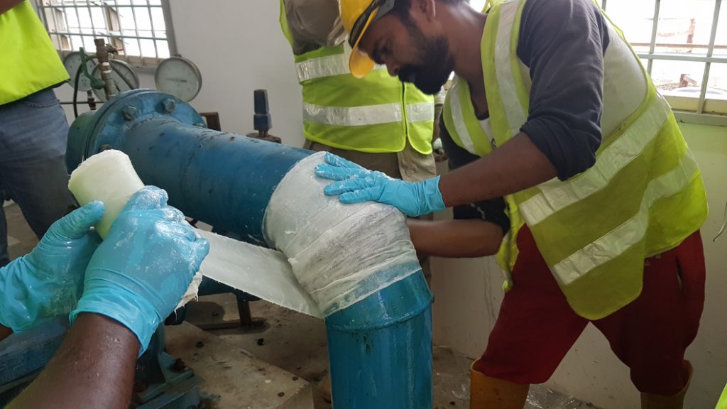 SylWrap HD being applied to a leaking steel elbow joint in Malaysia