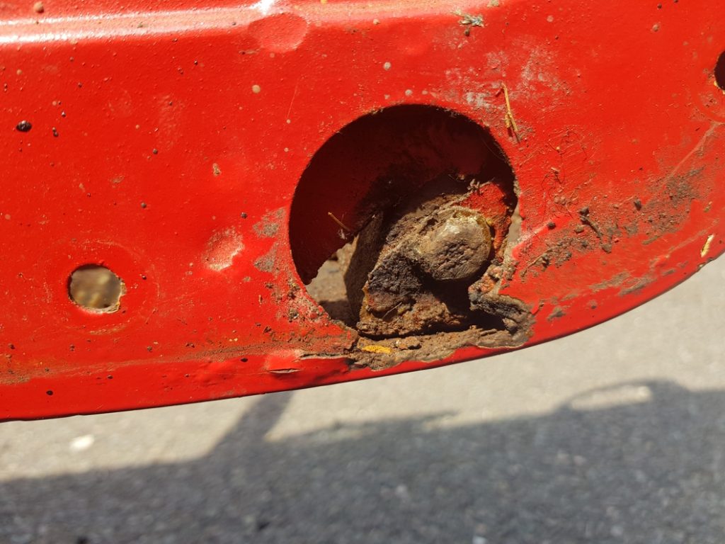 Rust holes in the door of a classic car before it underwent repair with Superfast Steel Epoxy Putty