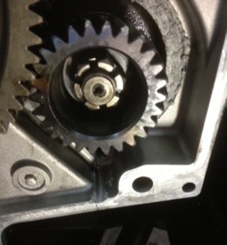 466 International engine timing cover with a hairline crack before undergoing repair with