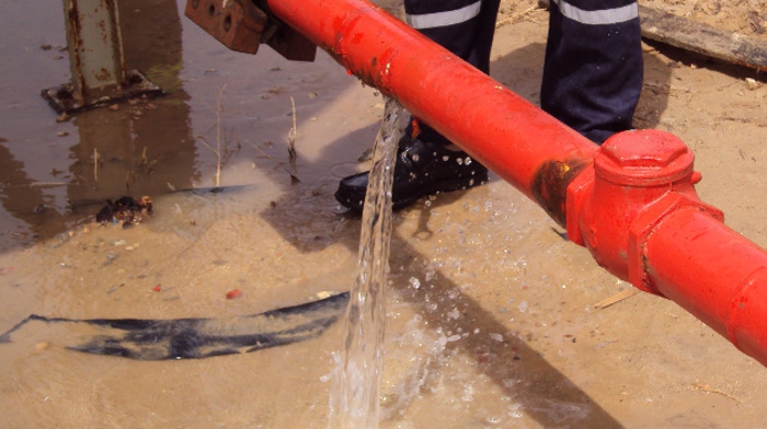 A significant leak in a water supply pipe in Libya before undergoing repair with a SylWrap Universal Pipe Repair Kit