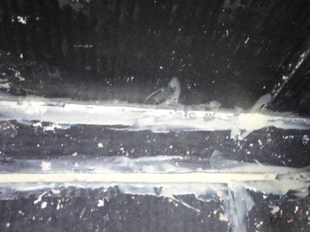 Sylmasta AB Original Epoxy Putty applied to seal gaps in a seawater storage tank floor repair application