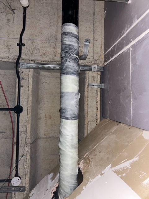 Cracked cast iron downpipe repair reinforced with a SylWrap Pipe Repair Bandage