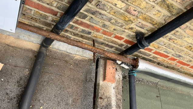 Poor quality lagging trapped moisture against a shared water supply pipe in London, requiring repair