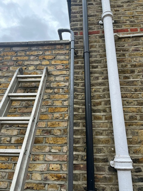 Shared water supply pipe running up side of building in London after repair with Liquid Metal Epoxy Coating