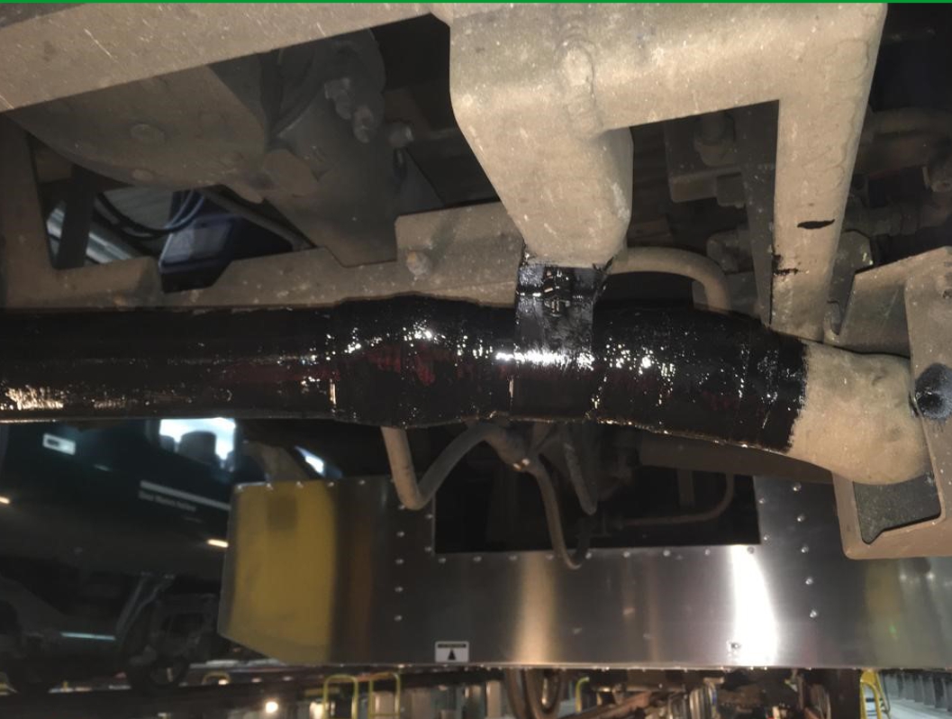 SylWrap HD Pipe Repair Bandage used to reinforce a damaged aluminium conduit pipe attached underneath a train