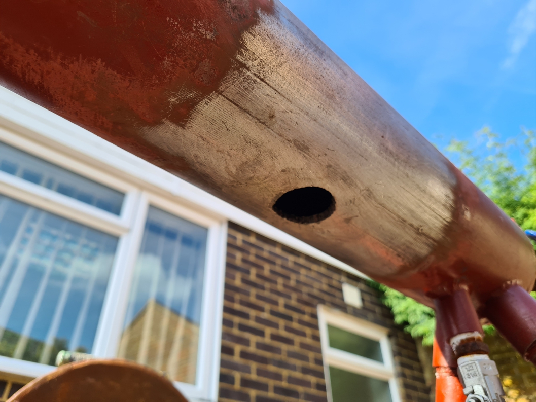 A 25mm hole cut into a 110mm diameter carbon steel pipe as part of testing ASME PCC-2 402-III leaking pipe repair testing