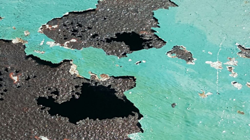 Corrosion having eaten through the roof of a tank at an pharmaceutical plant in Puerto Rico before repair 