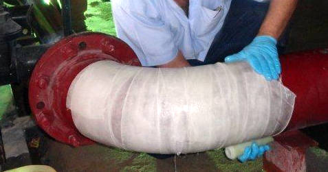 SylWrap HD Pipe Repair Bandage conforms to a 90 degree elbow bend during the reinforcement of a corroded steel pipeline at a fire station water pumping house in Saudi Arabia