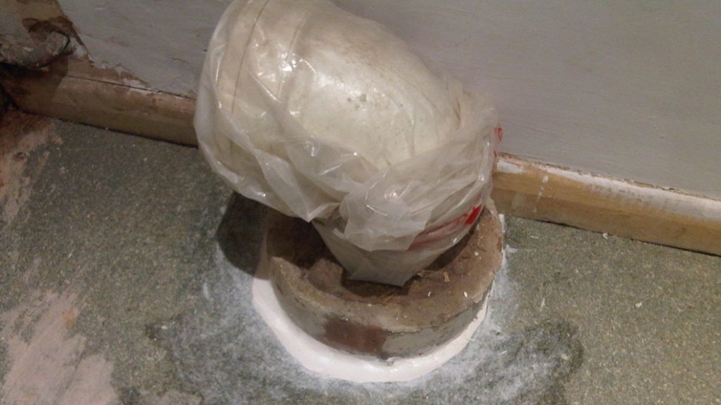 A cracked area between a floor and a toilet waste pipe undergoes successful repair using Sylmasta AB Original Epoxy Putty