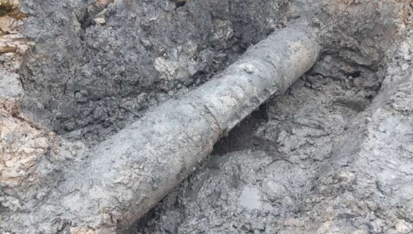A leaking effluent pipe running beneath a salt marsh before undergoing repair with SylWrap