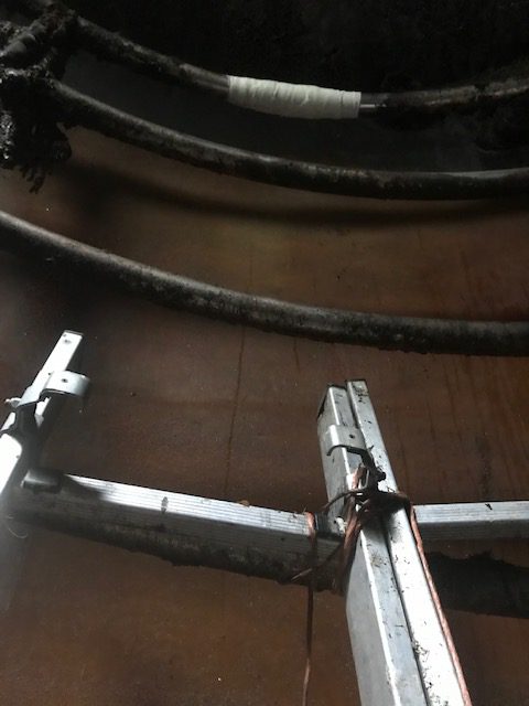 A stainless steel pipe in a farm biomass power plant heating tank could only be reached from a ladder when it required a leak repair