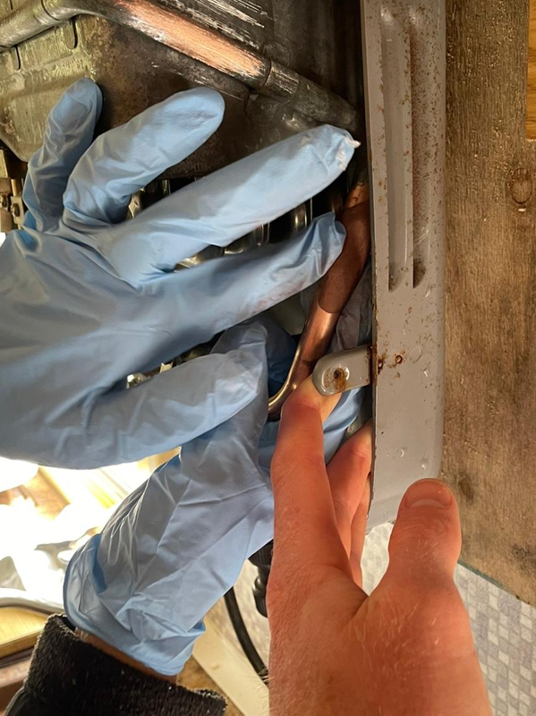 Superfast Copper Epoxy Putty being applied in the repair of a leaking pipe in a camper van boiler system