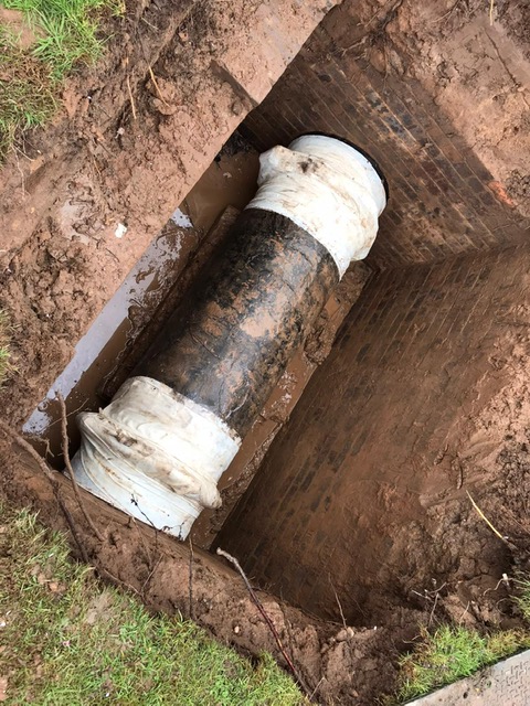 Repair of a leaking coupling joint in a disused pipe inspection pit made using SylWrap HD Pipe Repair Bandage