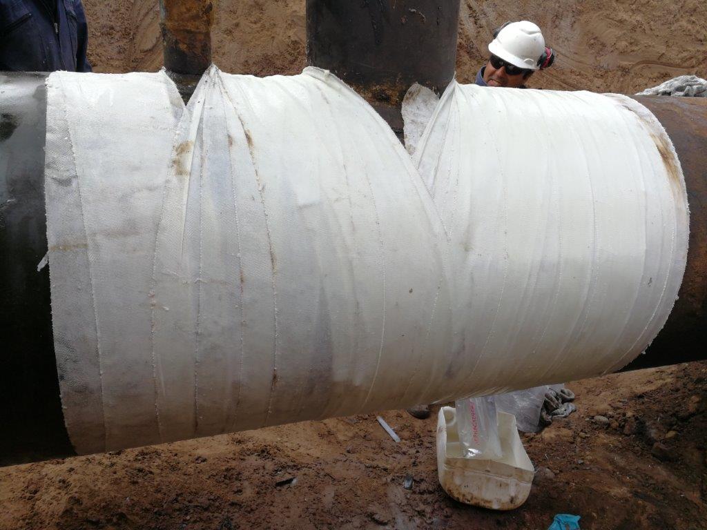 A 900mm steel pipe at an oil well undergoes repair and reinforcement using SylWrap HD Bandage