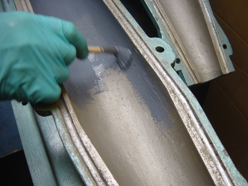 Ceramic Brushable Blue Epoxy Coating being applied to pug mill putty extruder barrels to create an abrasion resistant surface