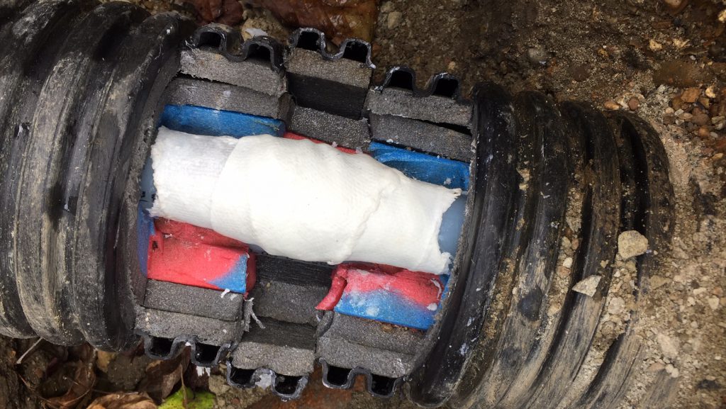 SylWrap HD Pipe Repair Bandage used to encompass an underground heating pipe with insulation lagging