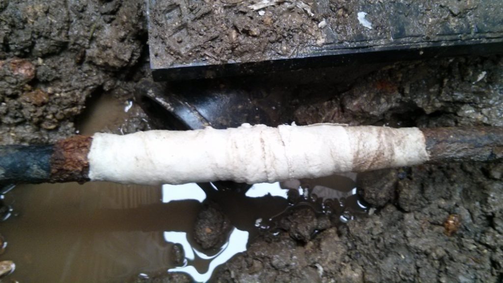 A 90-year-old malleable iron water supply pipe is kept in operation thanks to a SylWrap Pipe Repair Kit