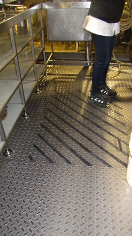 Stainless steel floor with anti slip installed using an epoxy coating