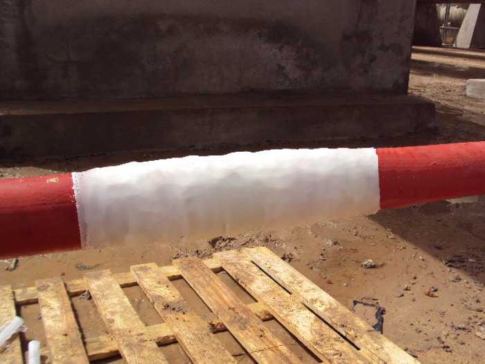 An above ground water supply pipe in Libya having undergone repair with a SylWrap Universal Pipe Repair Kit
