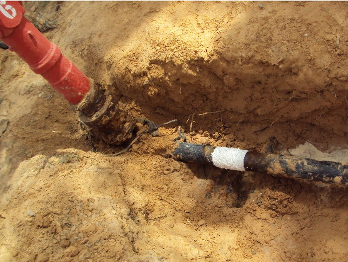 An underground water supply pipe in Libya is excavated before undergoing leak repair using a SylWrap Kit