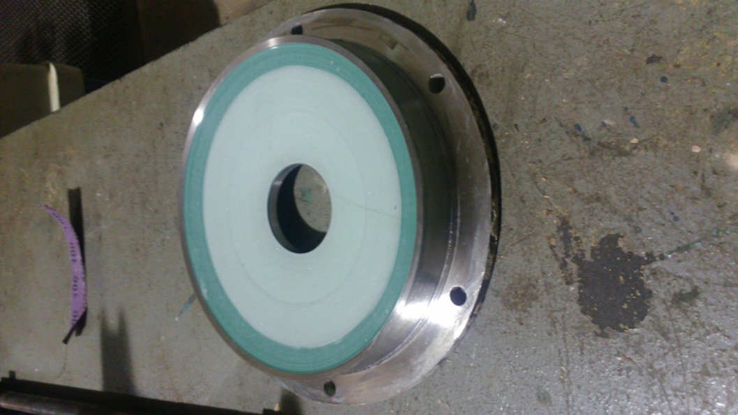 An alloy 20 pump lid having undergone repair using Ceramic Brushable Green Epoxy Coating